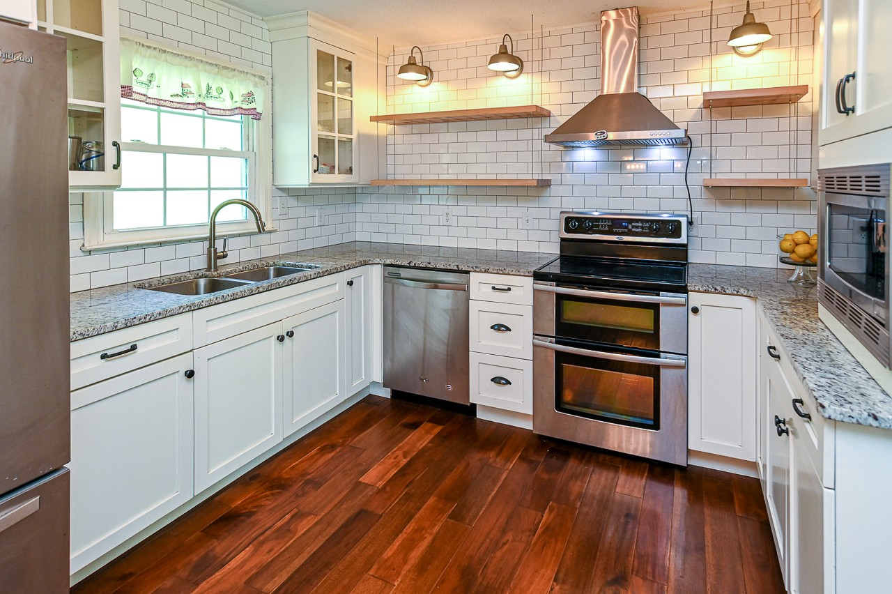 183 Lane Branch Road Fayetteville, TN 37334 - Photo 30 of 48 a kitchen with stainless steel appliances a stove a sink and wooden floor