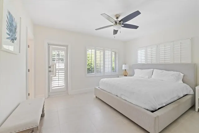 a bedroom with a large bed and window