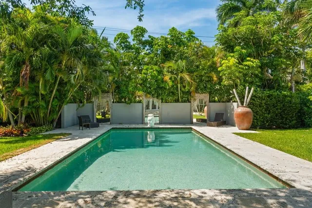 a view of a backyard with sitting area