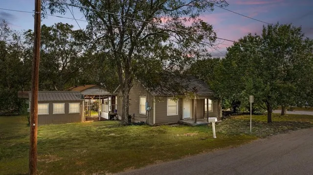 a front view of a house with a yard