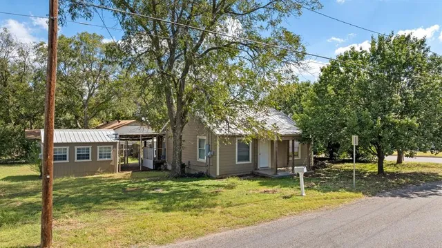 a front view of a house with a yard garage and outdoor seating