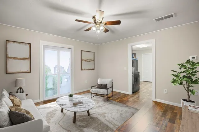 a living room with furniture and a potted plant