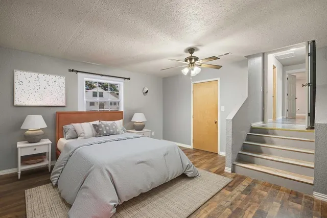 a spacious bedroom with a bed and a chandelier