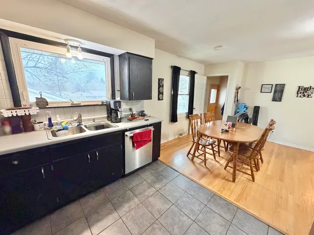 a room with a wooden cabinets dining table and chairs
