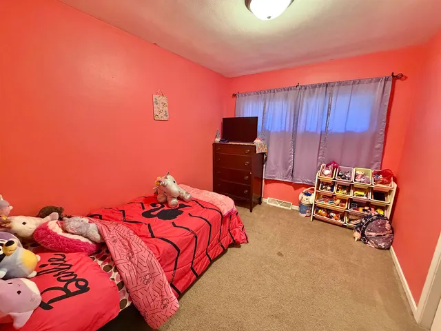 a bedroom with a bed and a television