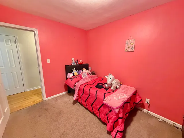 a bedroom with a bed and a mirror