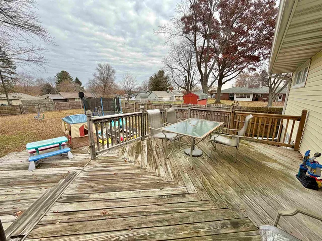 a view of a balcony with two chairs and a table