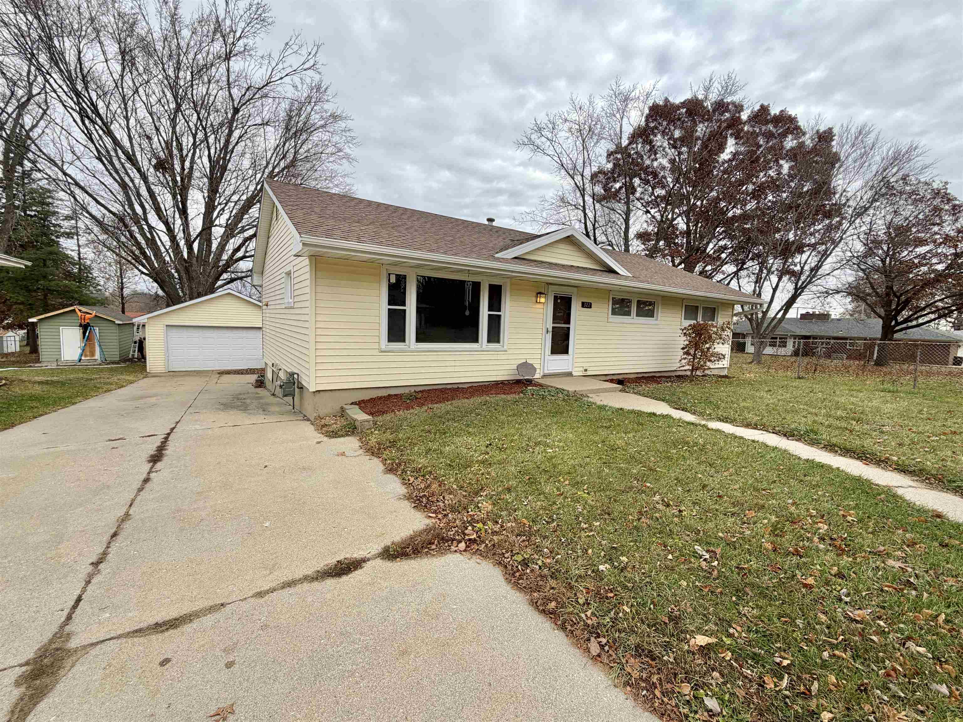 322 East 10th Street Pecatonica, IL 61063 - Photo 2 of 21 a view of a yard in front of a house with large trees