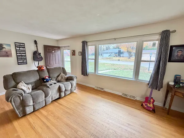 a large kitchen with stainless steel appliances kitchen island granite countertop a refrigerator and a stove top oven