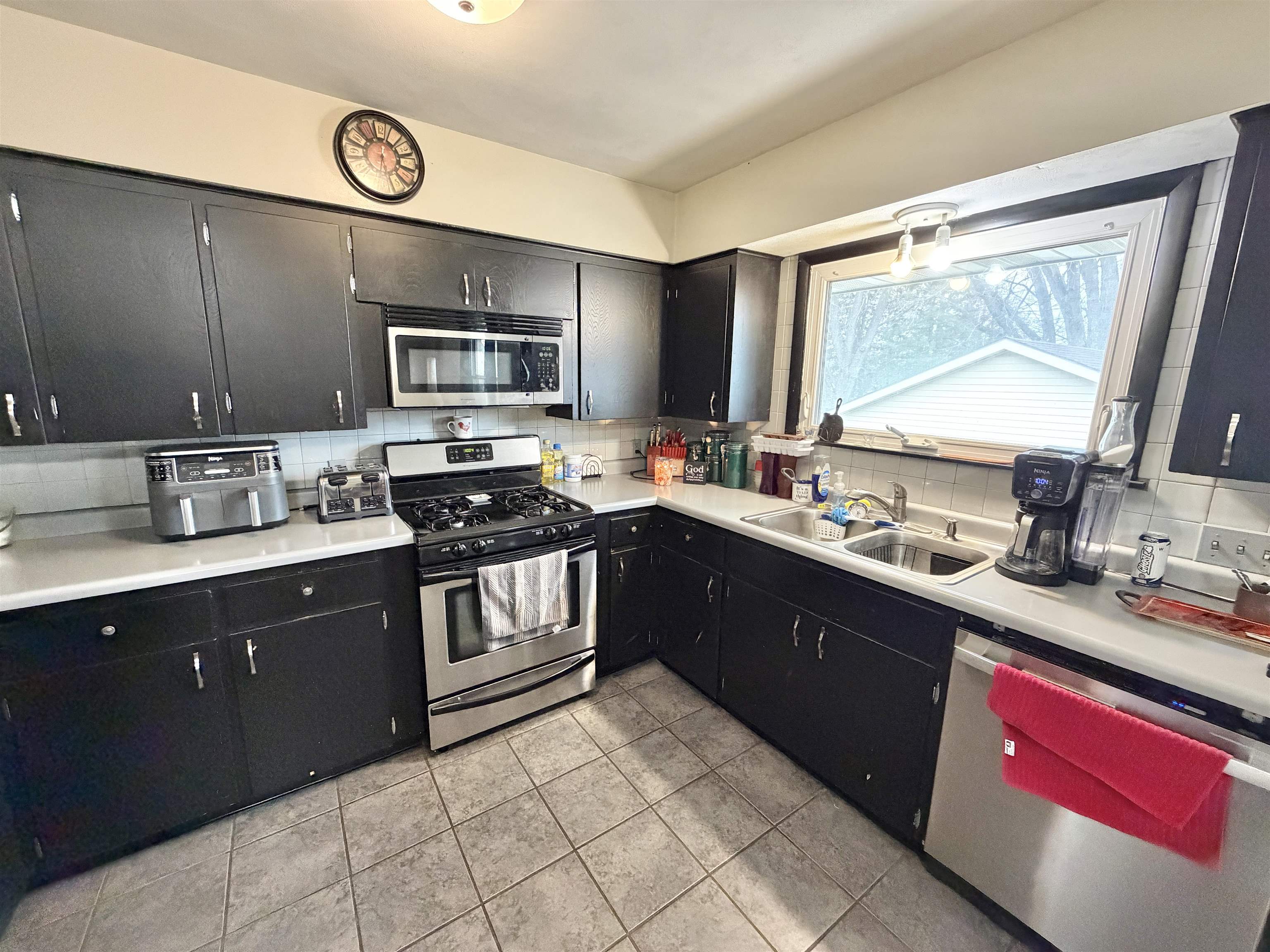 322 East 10th Street Pecatonica, IL 61063 - Photo 9 of 21 a kitchen with stainless steel appliances granite countertop a sink stove and refrigerator