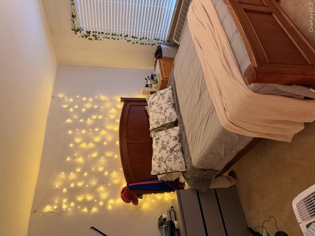 425 Shore Road, Unit 3A Long Beach, NY 11561 - Photo 11 of 17 a bedroom with a bed and a night stand