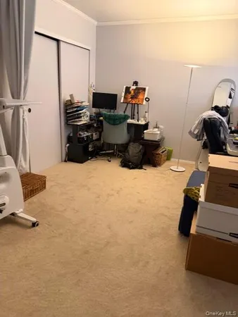 a room with gym equipment and a view of living room