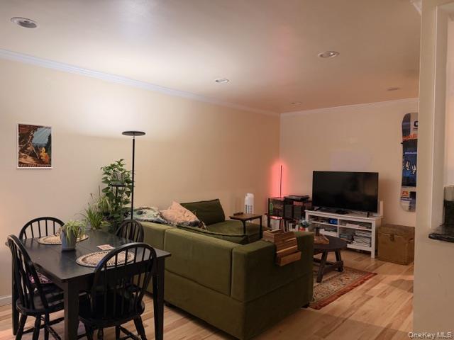 425 Shore Road, Unit 3A Long Beach, NY 11561 - Photo 3 of 17 a living room with furniture and a flat screen tv