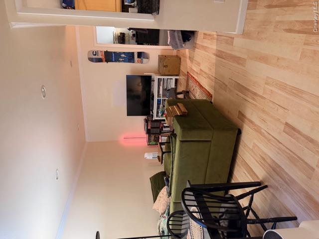 425 Shore Road, Unit 3A Long Beach, NY 11561 - Photo 6 of 17 a living room with furniture and a flat screen tv