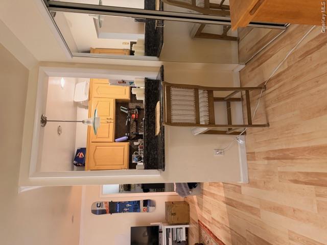 425 Shore Road, Unit 3A Long Beach, NY 11561 - Photo 7 of 17 a view of a kitchen with kitchen island granite countertop wooden floor and a sink