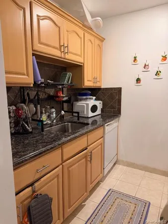 a kitchen with stainless steel appliances granite countertop a sink stove and microwave