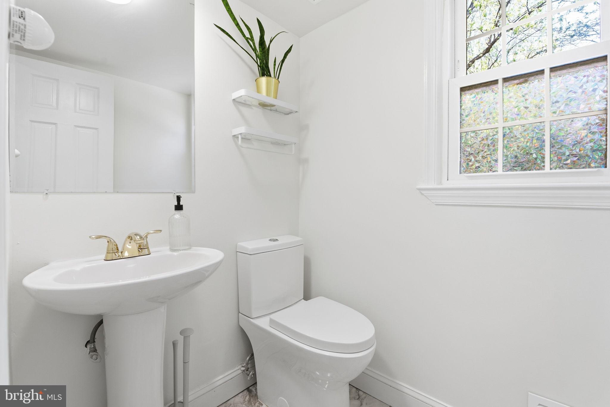 15101 Redgate Drive Silver Spring, MD 20905 - Photo 21 of 39 a bathroom with a sink toilet and a mirror