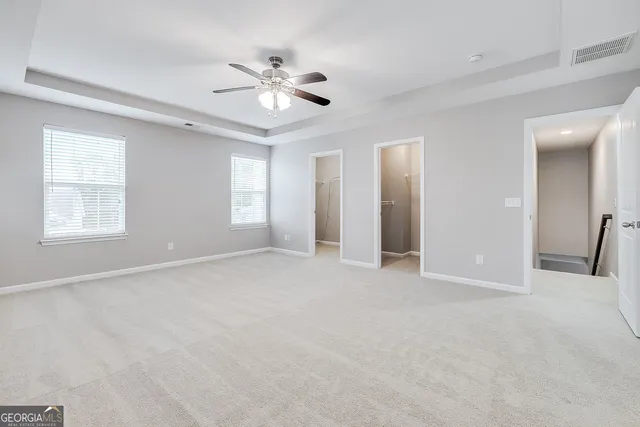 a view of an empty room with a ceiling fan