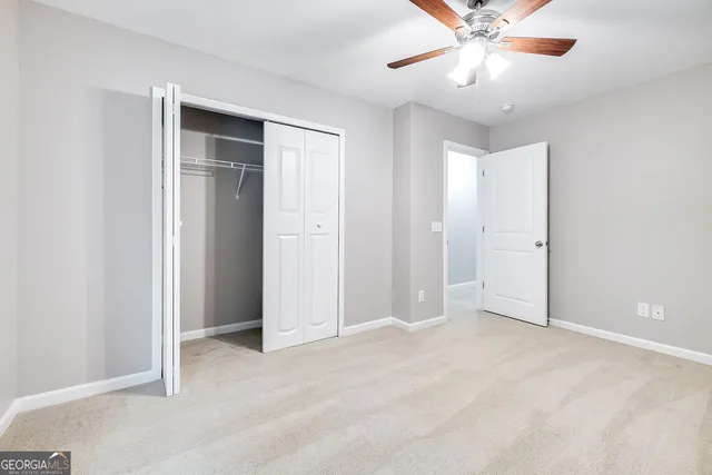 a bathroom with a granite countertop sink and a toilet