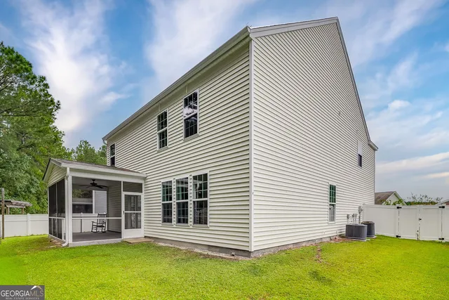 a view of a house with a swimming pool and a yard