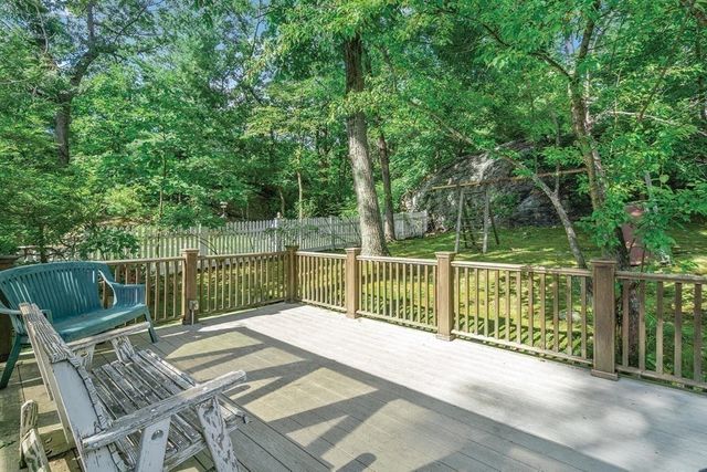a view of a balcony with wooden floor