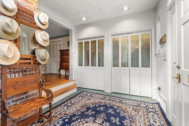 a view of an entryway with wooden floor and door