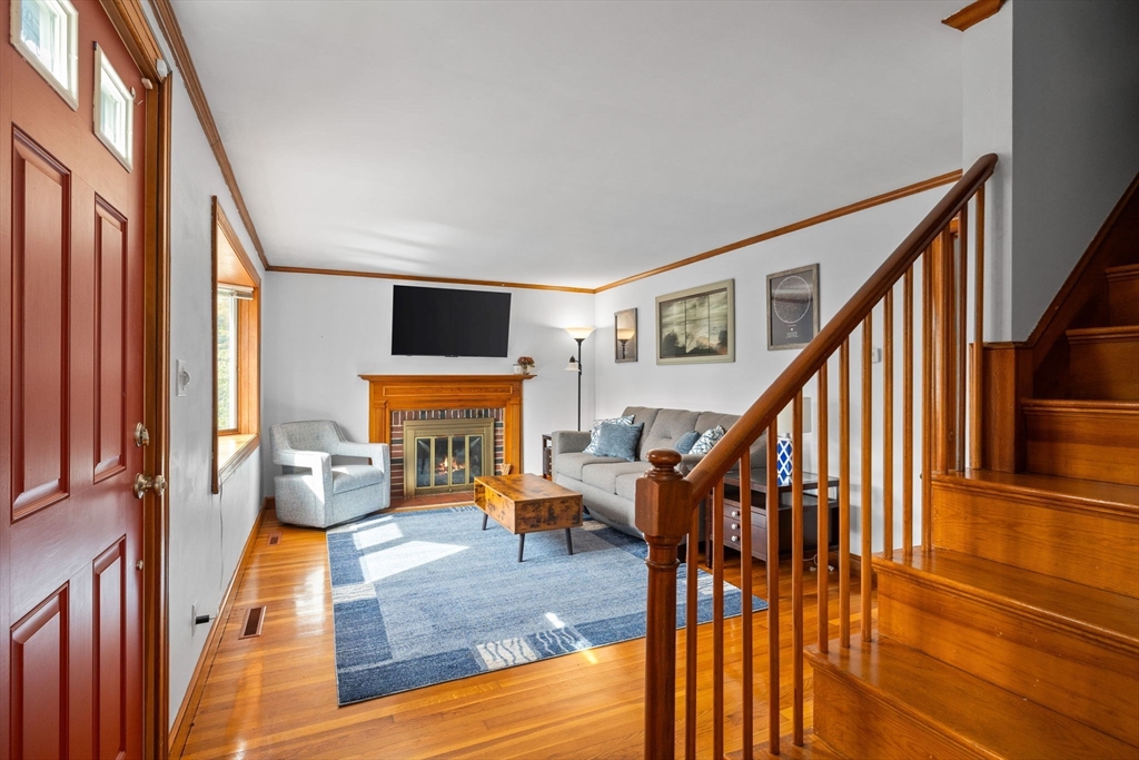 17 Spring Street Wakefield, MA 01880 - Photo 15 of 31 a living room with fireplace furniture dining table and a flat screen tv