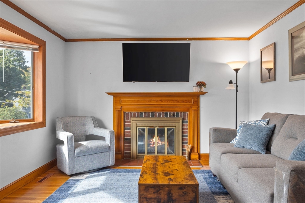 17 Spring Street Wakefield, MA 01880 - Photo 3 of 31 a living room with furniture and a fireplace