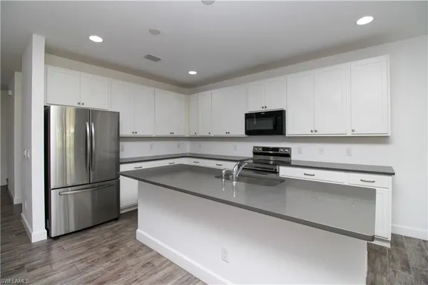 a kitchen with a refrigerator stove and microwave