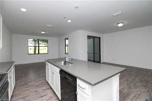 a kitchen with a sink and chandelier