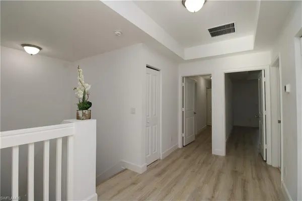 a view of hallway with wooden floor
