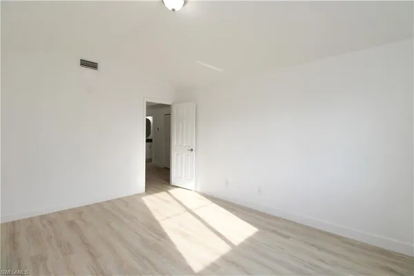 a view of an empty room and wooden floor