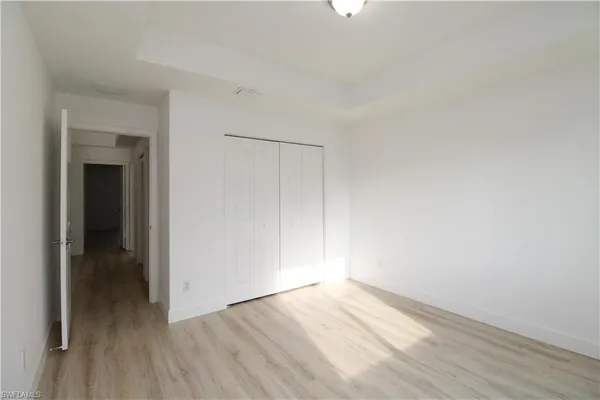a view of an empty room and wooden floor