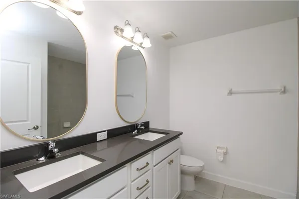 a bathroom with a double vanity sink and a mirror