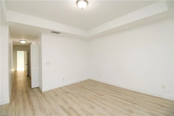 a view of a room with wooden floor