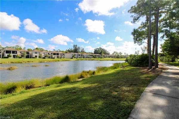 a view of a lake with houses in the back