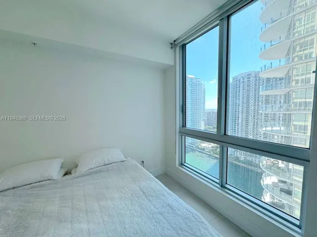 a bathroom with a double vanity sink and a window