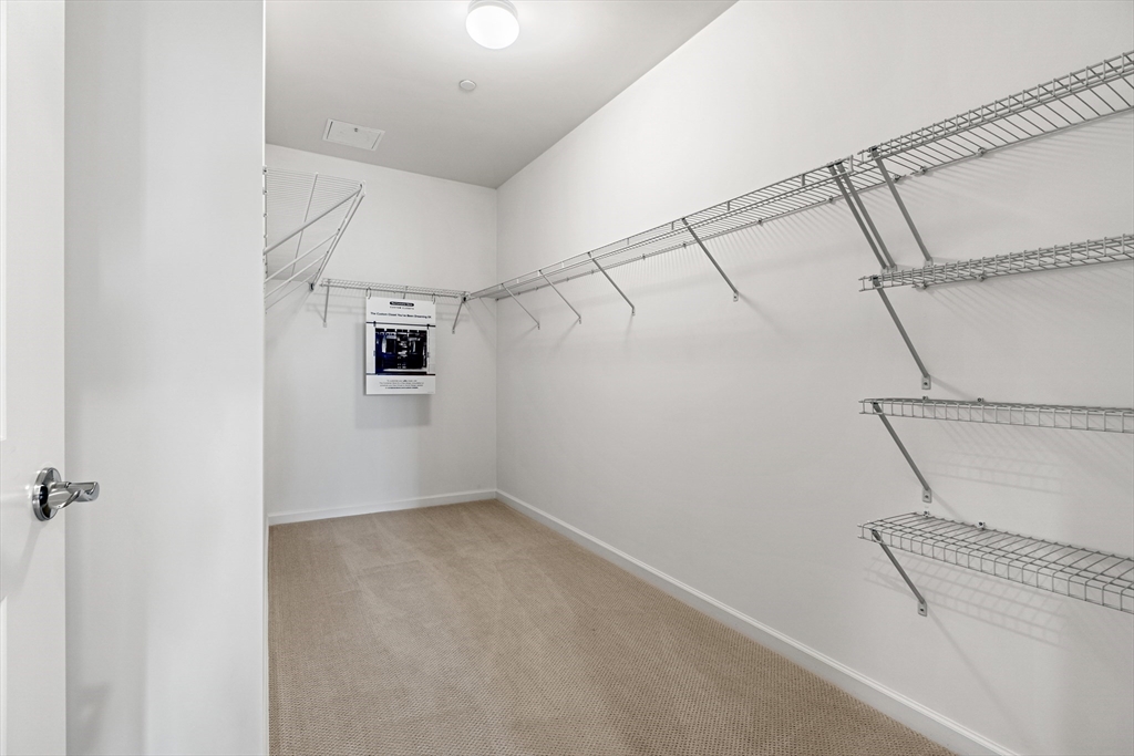 2 Codman Way, Unit 207 Westborough, MA 01581 - Photo 21 of 40 a view of a room with racks on the wall