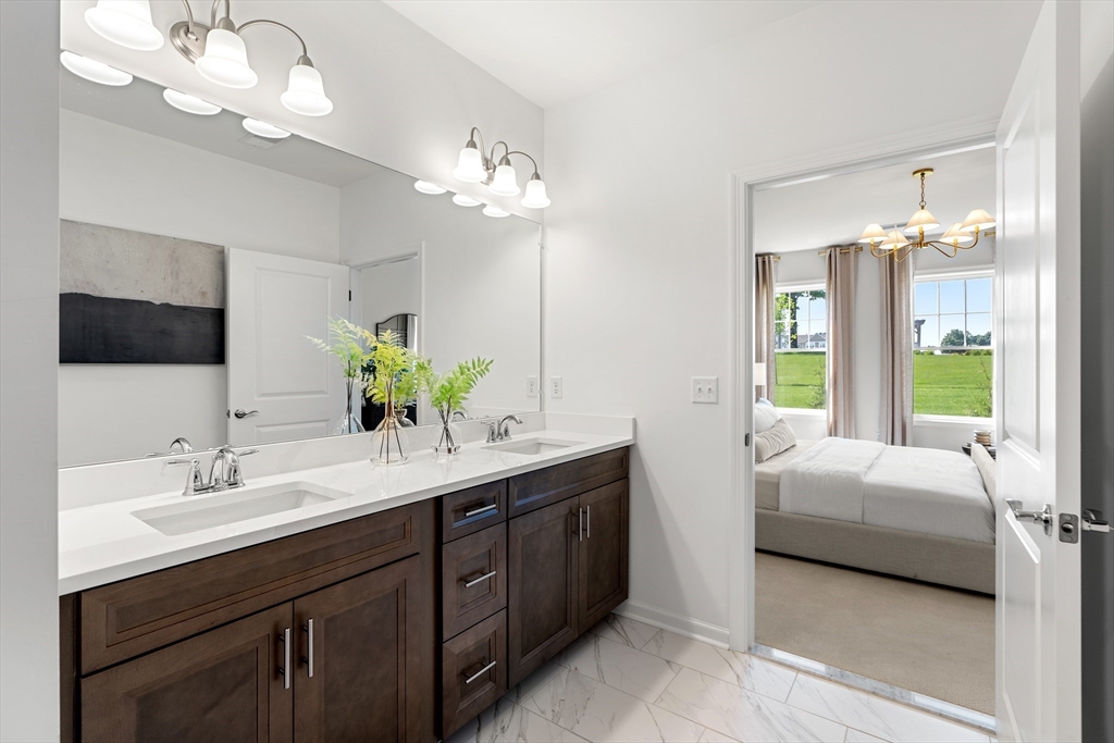 2 Codman Way, Unit 207 Westborough, MA 01581 - Photo 22 of 40 a bathroom with a double vanity sink and a mirror