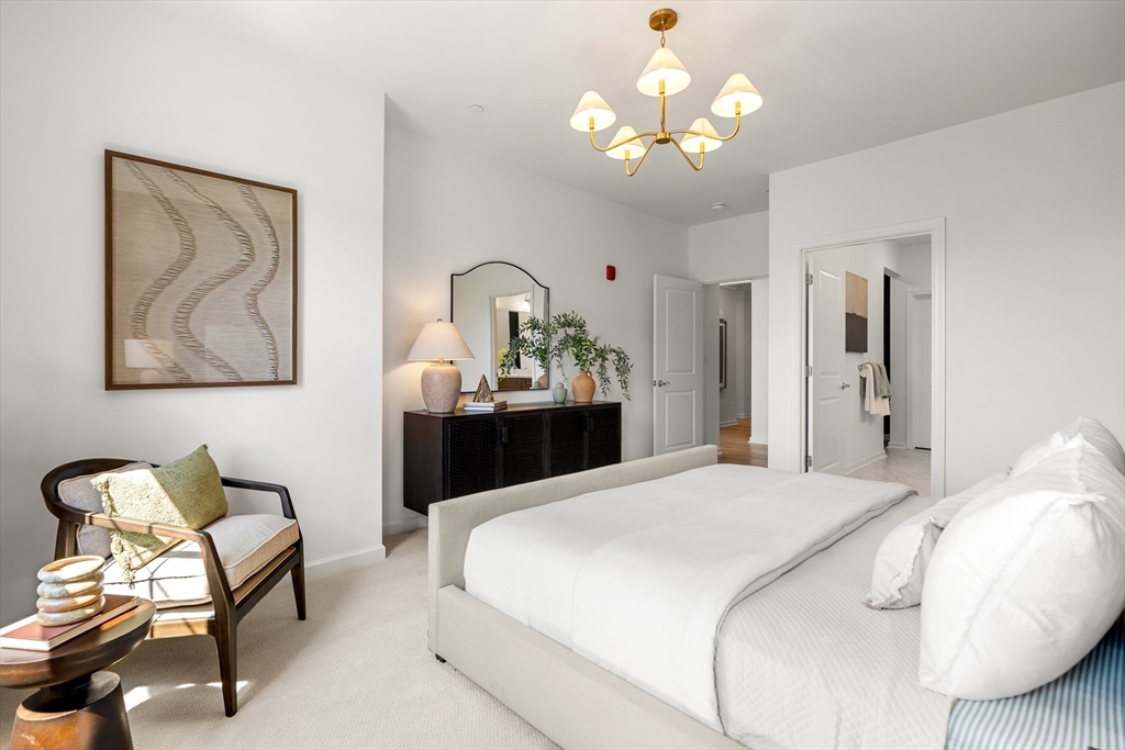 2 Codman Way, Unit 207 Westborough, MA 01581 - Photo 26 of 40 a bedroom with a bed and a chandelier