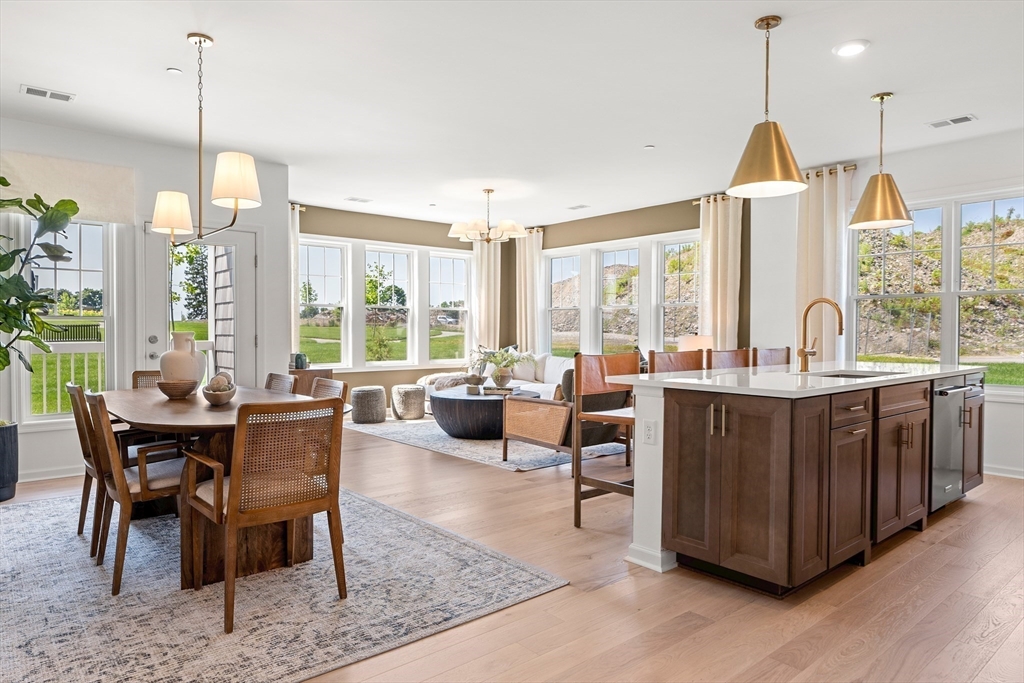 2 Codman Way, Unit 207 Westborough, MA 01581 - Photo 3 of 40 a dining room with furniture a chandelier and wooden floor