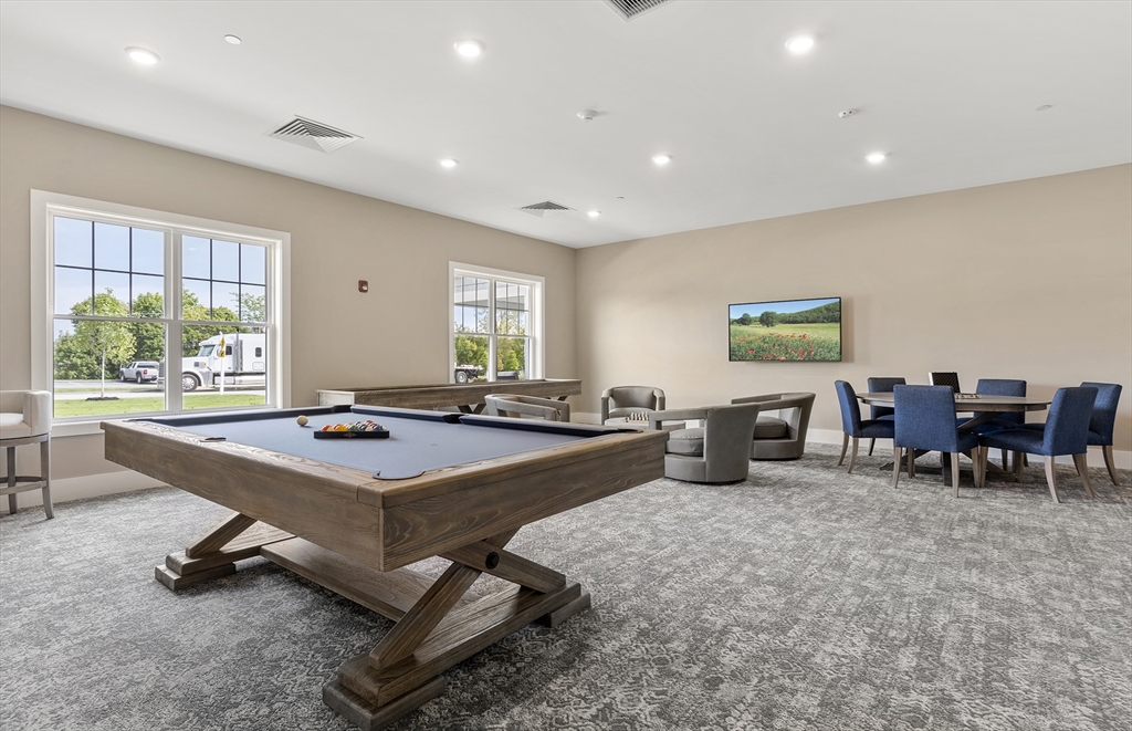 2 Codman Way, Unit 207 Westborough, MA 01581 - Photo 38 of 40 a living room with furniture a pool table and a large window
