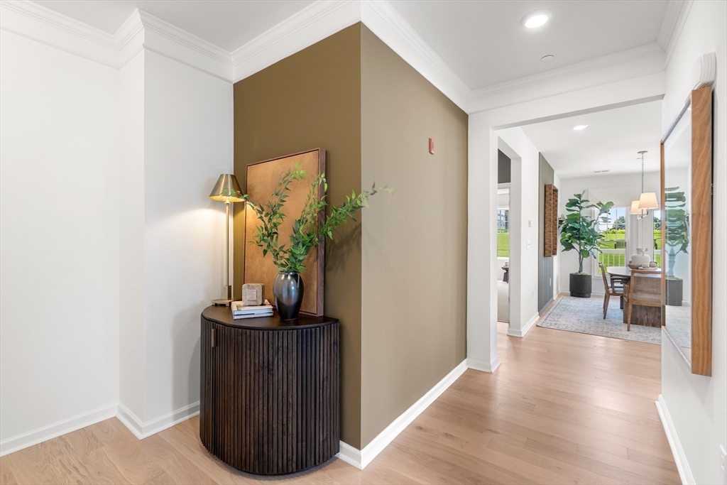 2 Codman Way, Unit 207 Westborough, MA 01581 - Photo 5 of 40 a view of a hallway with wooden floor and a bathroom