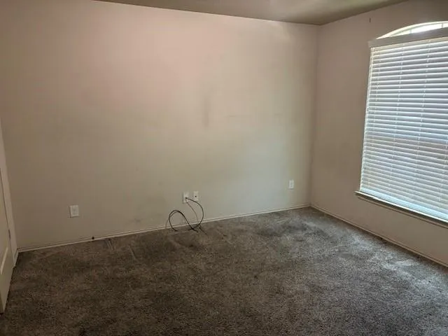 a hallway with sliding door and front door
