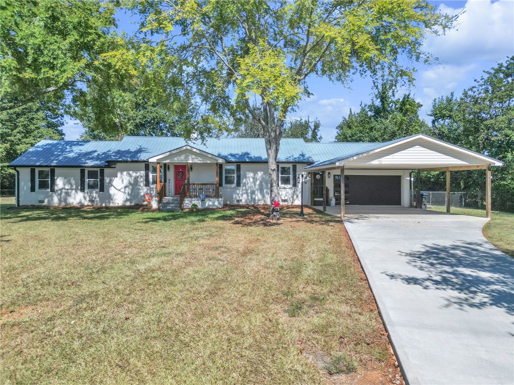 1048 Old Gantt Mill Road Anderson, SC 29625 - Photo 1 of 30 A spacious driveway leads to this charming ranch home with a metal roof.