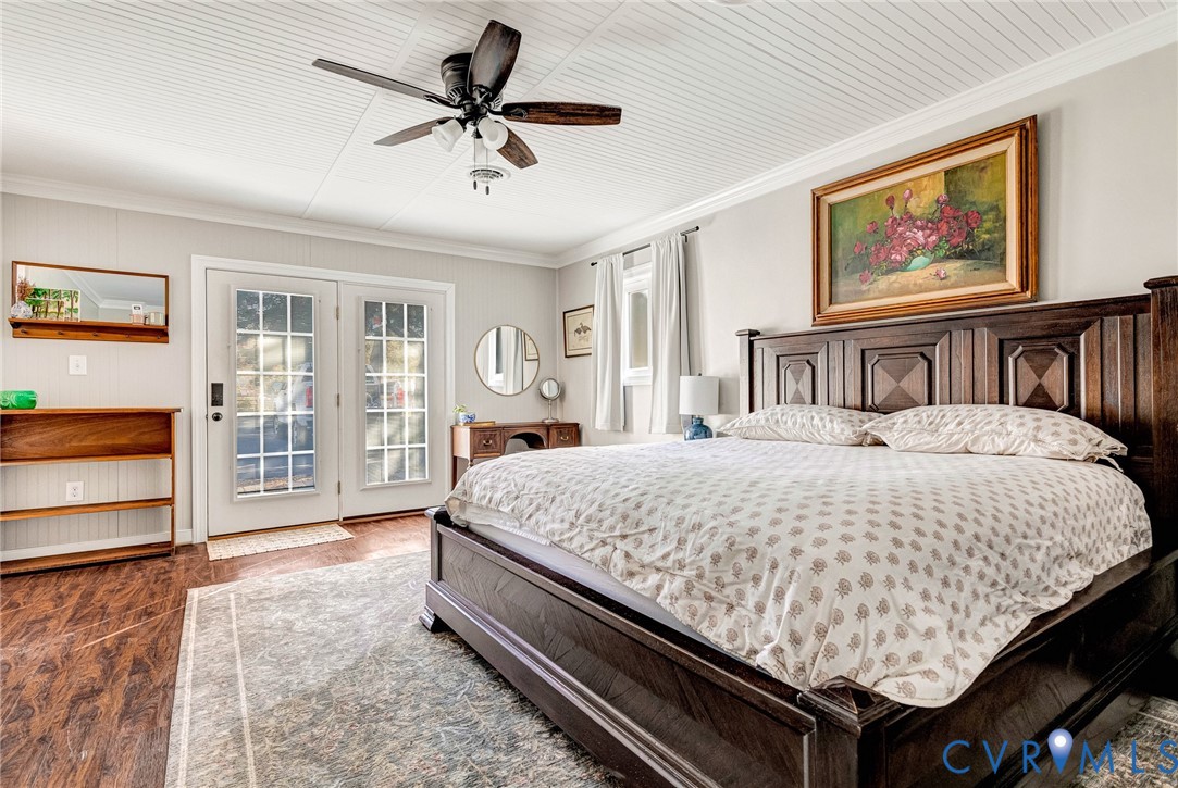 700 West Riverside Drive Lanexa, VA 23089 - Photo 11 of 44 a bedroom with a large bed and a chandelier