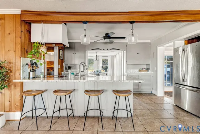 a kitchen with stainless steel appliances granite countertop a refrigerator and a stove top oven