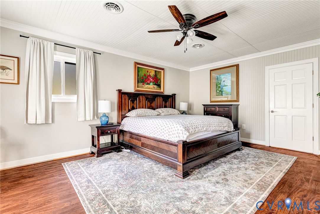 700 West Riverside Drive Lanexa, VA 23089 - Photo 25 of 44 a bedroom with a bed a dresser and wooden floor