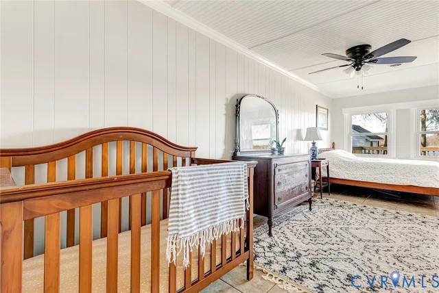 a bedroom with a bed next to a large window with the outer view