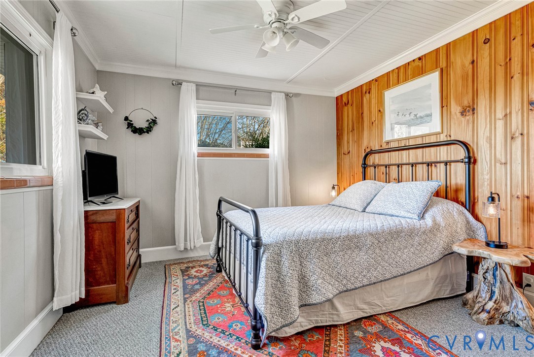700 West Riverside Drive Lanexa, VA 23089 - Photo 32 of 44 a bedroom with a bed and a flat tv screen on dresser